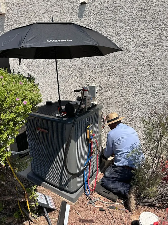 HVAC technician performing outdoor AC maintenance in Potsdam